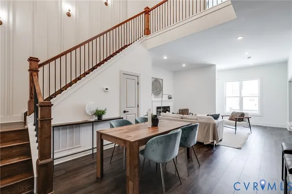a view of a a dining room with furniture window and wooden floor