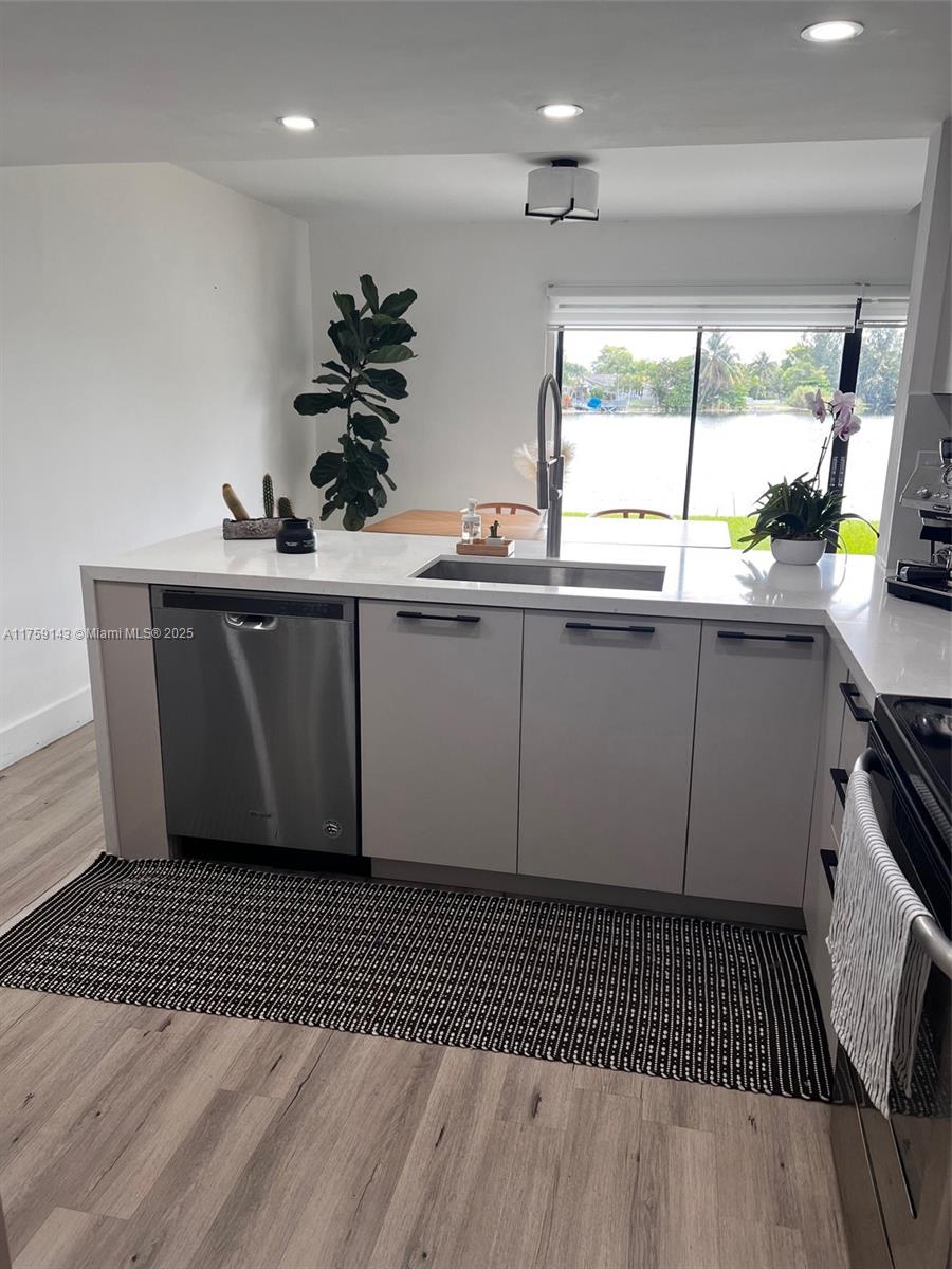 1351 Southwest 124th Court, Unit B5 Miami, FL 33184 - Photo 13 of 37 a kitchen with a sink a window and cabinets