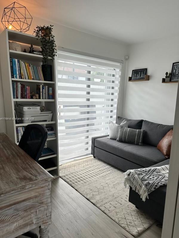1351 Southwest 124th Court, Unit B5 Miami, FL 33184 - Photo 20 of 37 a living room with a couch and a book shelf