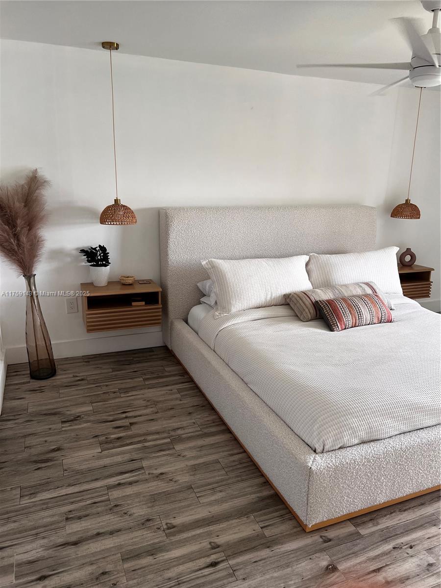 1351 Southwest 124th Court, Unit B5 Miami, FL 33184 - Photo 26 of 37 a bedroom with a bed and wooden floor