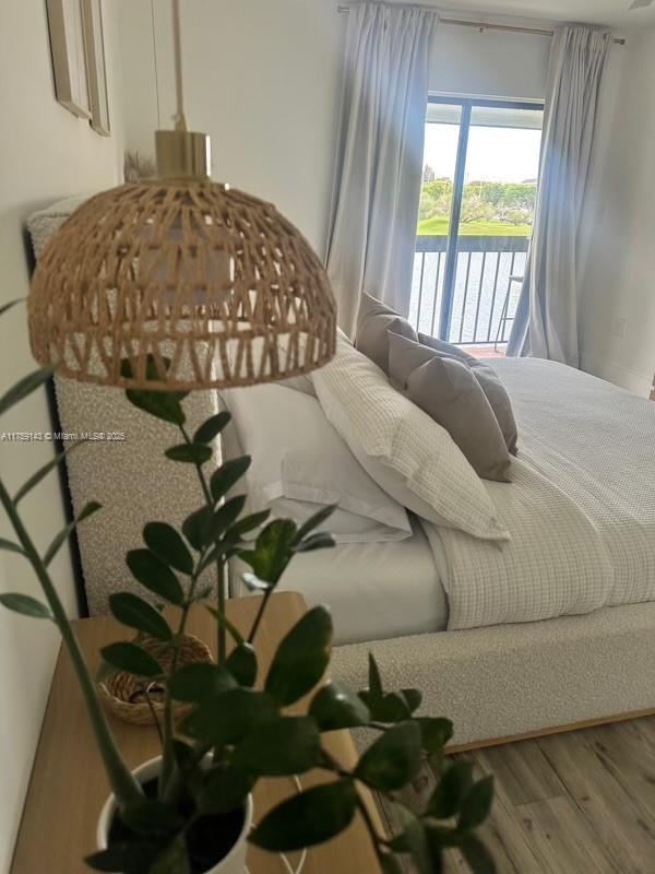 1351 Southwest 124th Court, Unit B5 Miami, FL 33184 - Photo 29 of 37 a bed sitting in a bedroom next to a window