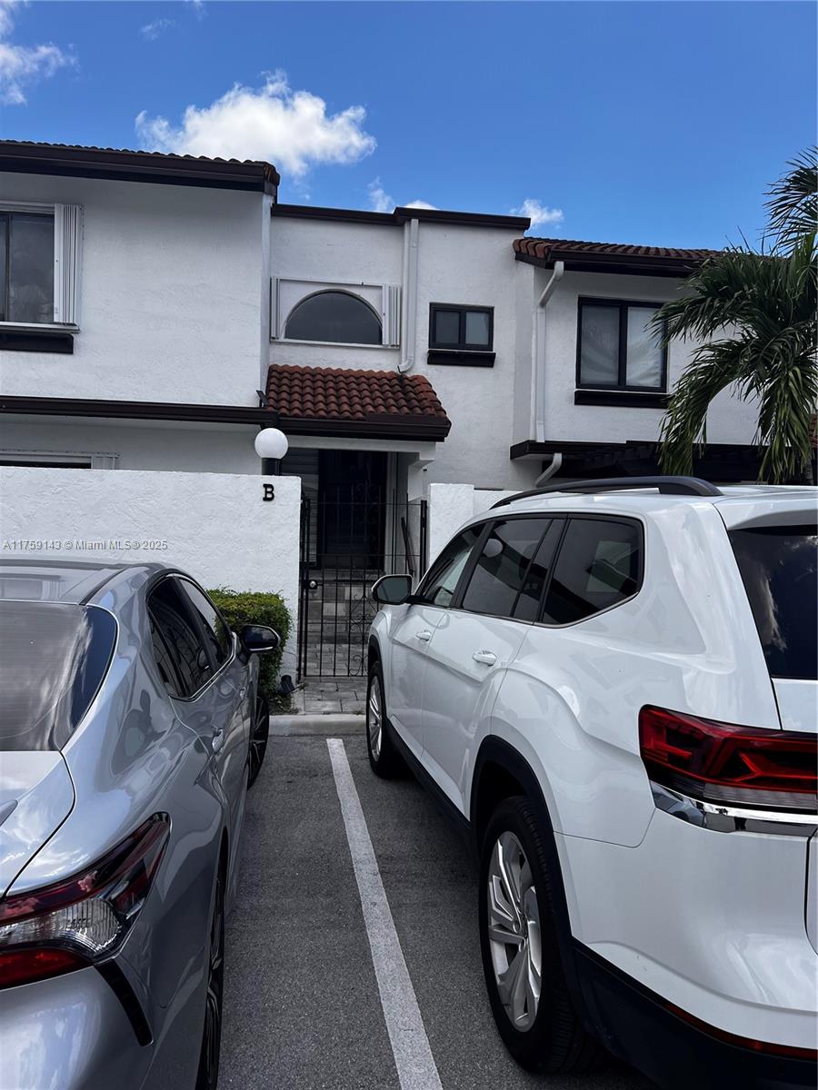 1351 Southwest 124th Court, Unit B5 Miami, FL 33184 - Photo 37 of 37 a front view of a house with parking space