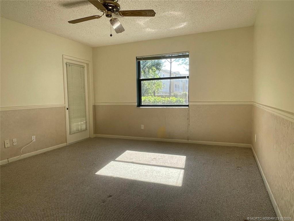 1270 Southeast Parkview Place, Unit B3 Stuart, FL 34994 - Photo 18 of 40 an empty room with a window and a ceiling fan