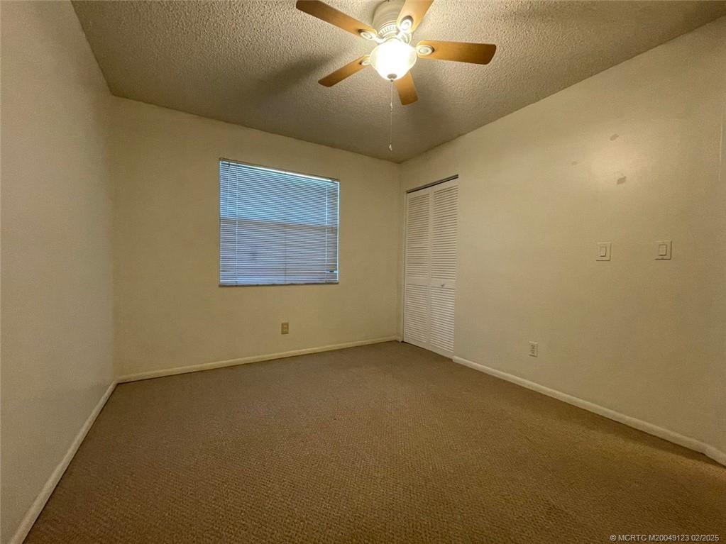 1270 Southeast Parkview Place, Unit B3 Stuart, FL 34994 - Photo 21 of 40 an empty room with a window and a fan