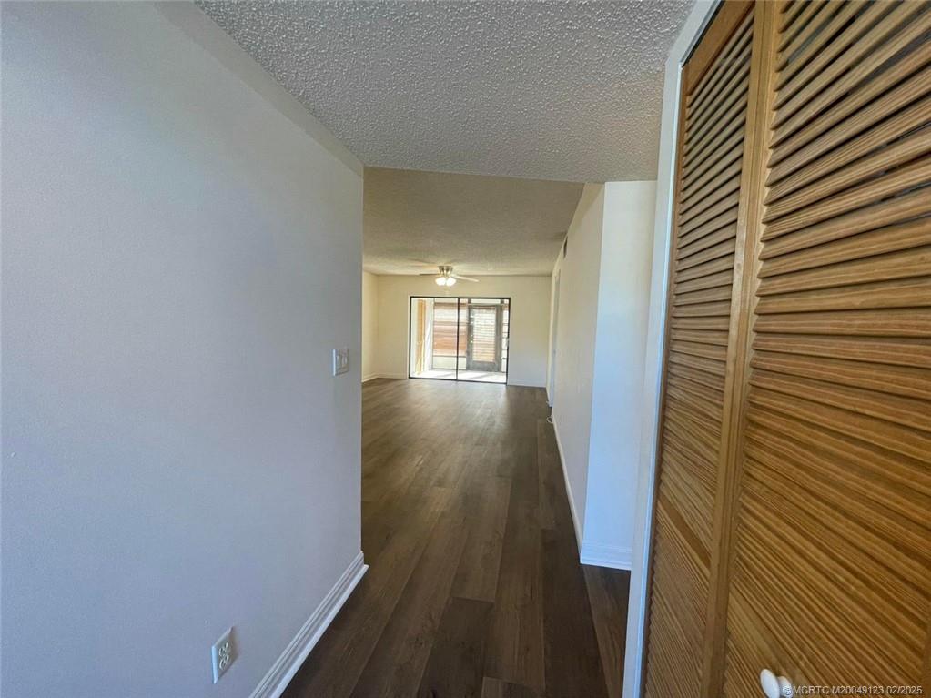 1270 Southeast Parkview Place, Unit B3 Stuart, FL 34994 - Photo 8 of 40 a view of a hallway with wooden floor and staircase