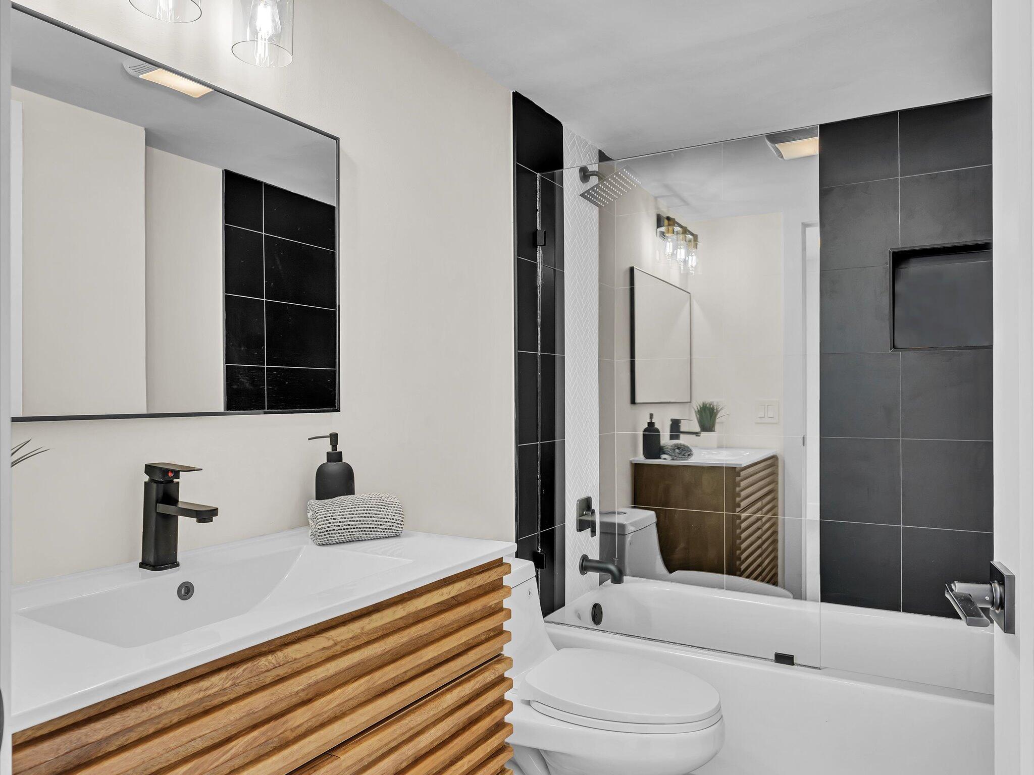 21 Royal Palm Way, Unit 3030 Boca Raton, FL 33432 - Photo 19 of 24 a bathroom with a sink a toilet and shower