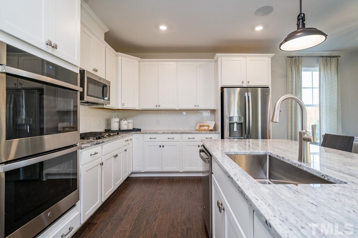 2201 Goudy Drive Raleigh, NC 27615 - Photo 16 of 24 a kitchen with stainless steel appliances granite countertop a sink stove and refrigerator