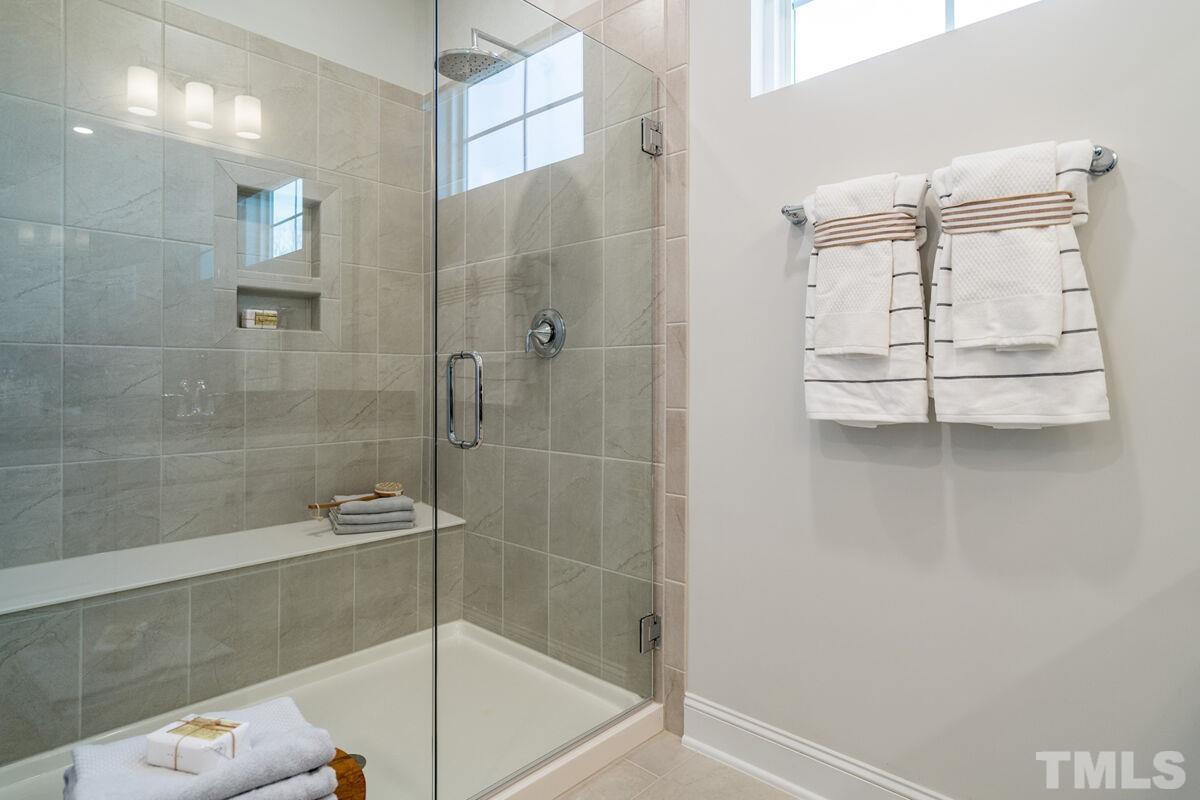 2201 Goudy Drive Raleigh, NC 27615 - Photo 19 of 24 a bathroom with a glass shower door