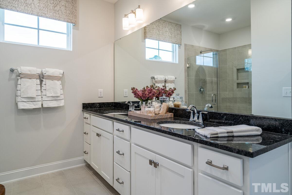 2201 Goudy Drive Raleigh, NC 27615 - Photo 20 of 24 a bathroom with a sink and a mirror