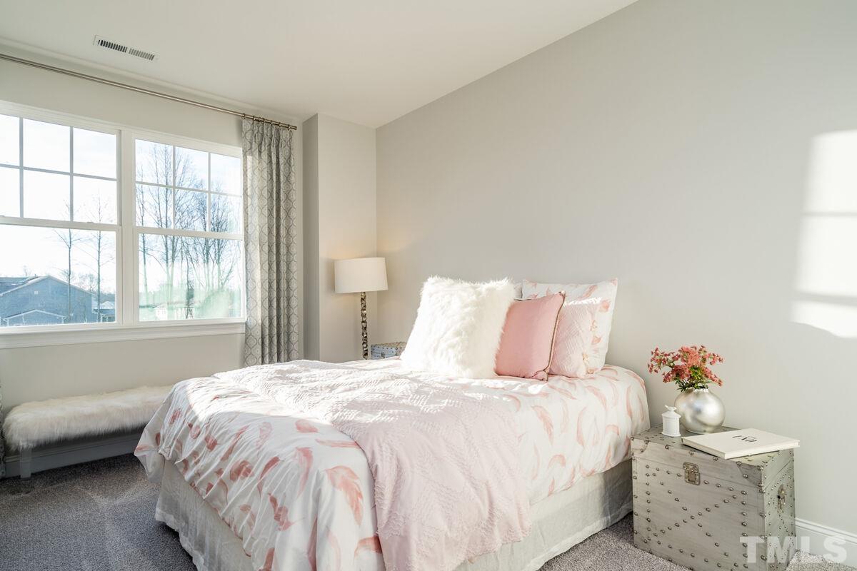 2201 Goudy Drive Raleigh, NC 27615 - Photo 21 of 24 a bedroom with a bed and a window