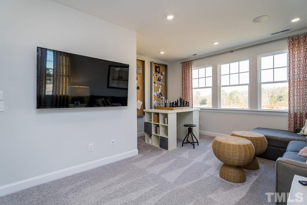 2201 Goudy Drive Raleigh, NC 27615 - Photo 23 of 24 a living room with furniture and a flat screen tv