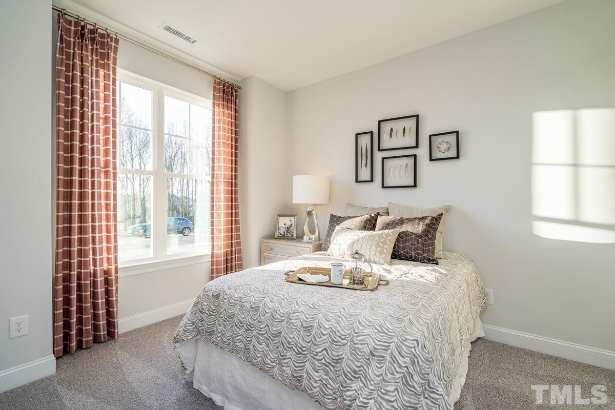 2201 Goudy Drive Raleigh, NC 27615 - Photo 6 of 24 a bedroom with a bed and wooden floor