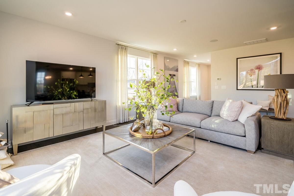 2201 Goudy Drive Raleigh, NC 27615 - Photo 10 of 24 a living room with furniture a flat screen tv and a window