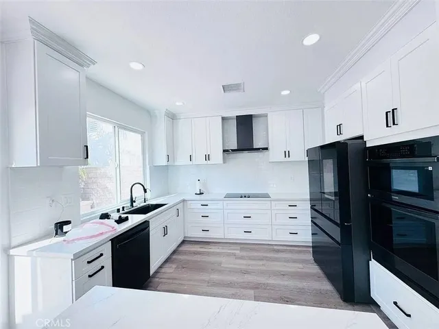 a kitchen with stainless steel appliances a refrigerator stove and sink