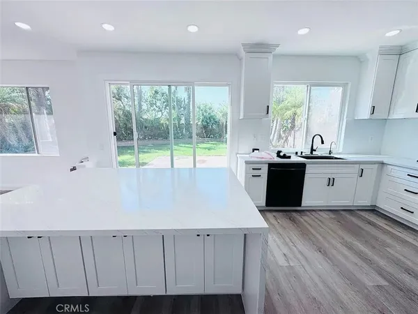a view of kitchen with wooden floor and sink