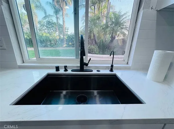 a close view of kitchen sink with outdoor space