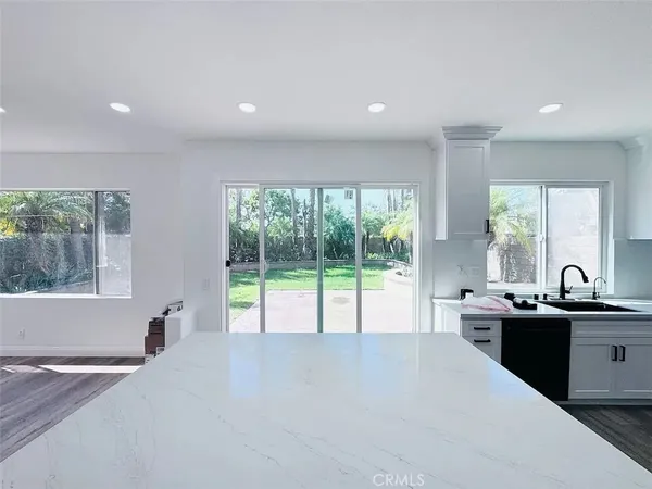 a kitchen with a sink and large window
