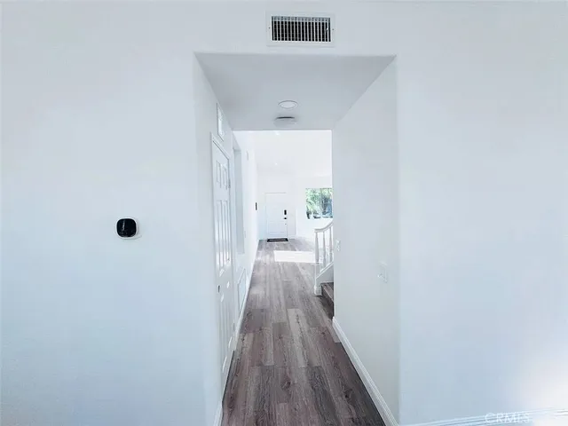 a view of hallway with wooden floor