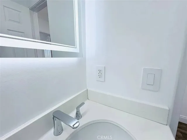 a view of a room with wooden floor and window