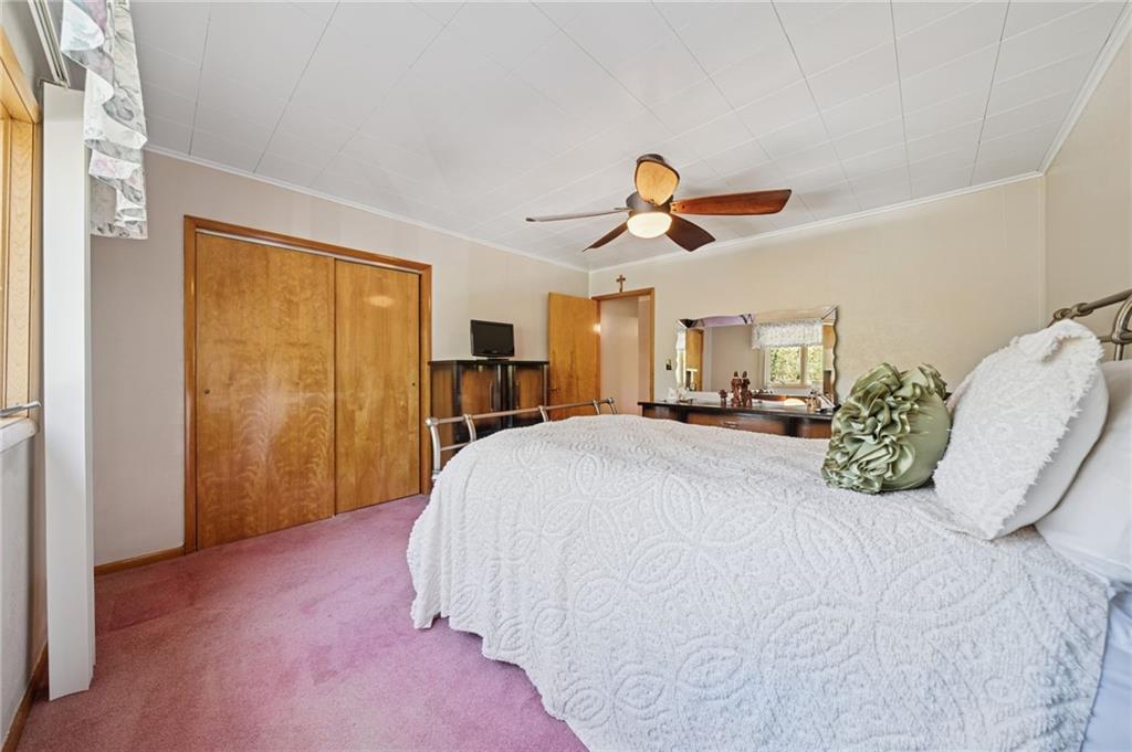 19 Hoon Street Monongahela, PA 15063 - Photo 16 of 37 a bedroom with a large bed and a ceiling fan