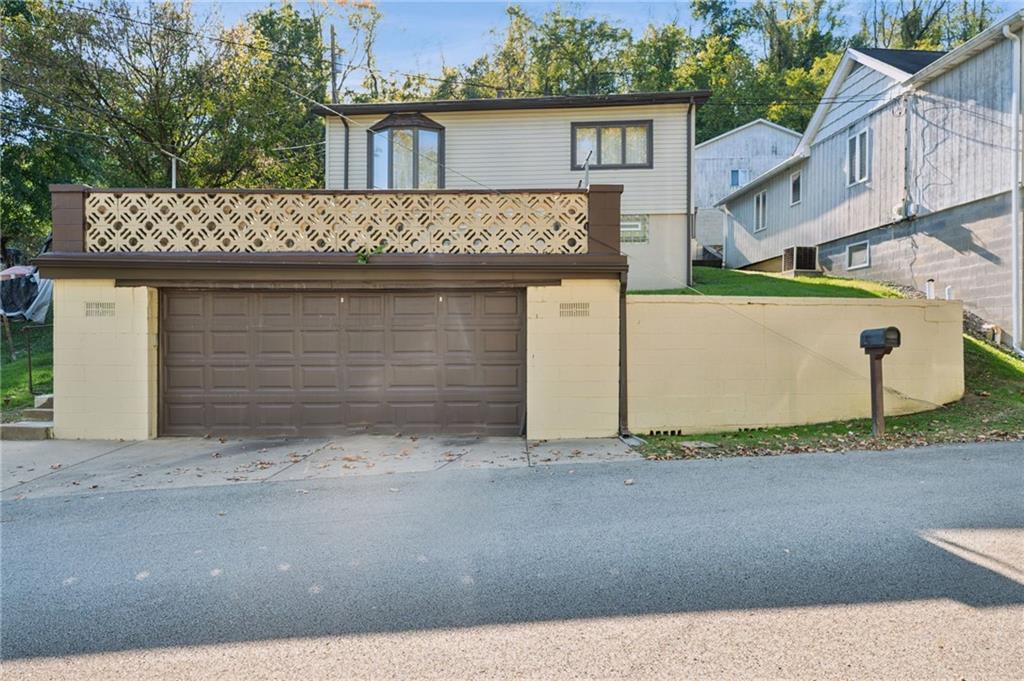 19 Hoon Street Monongahela, PA 15063 - Photo 2 of 37 a front view of a house with a yard and garage