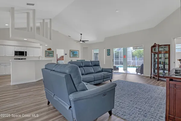 a room with furniture a flat screen tv and a book shelf