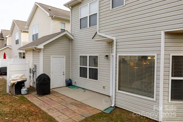 a view of a house with a yard and furniture
