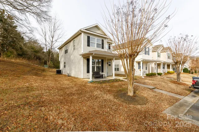 a view of a large trees with brick walls