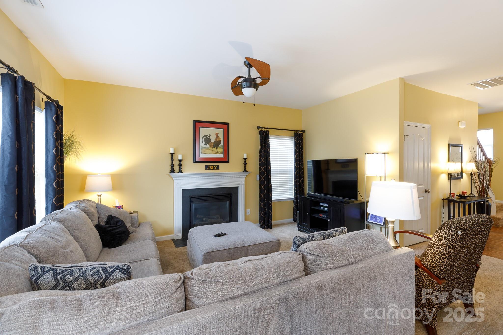 722 Chelton Lane Fort Mill, SC 29715 - Photo 5 of 19 a living room with furniture and a flat screen tv