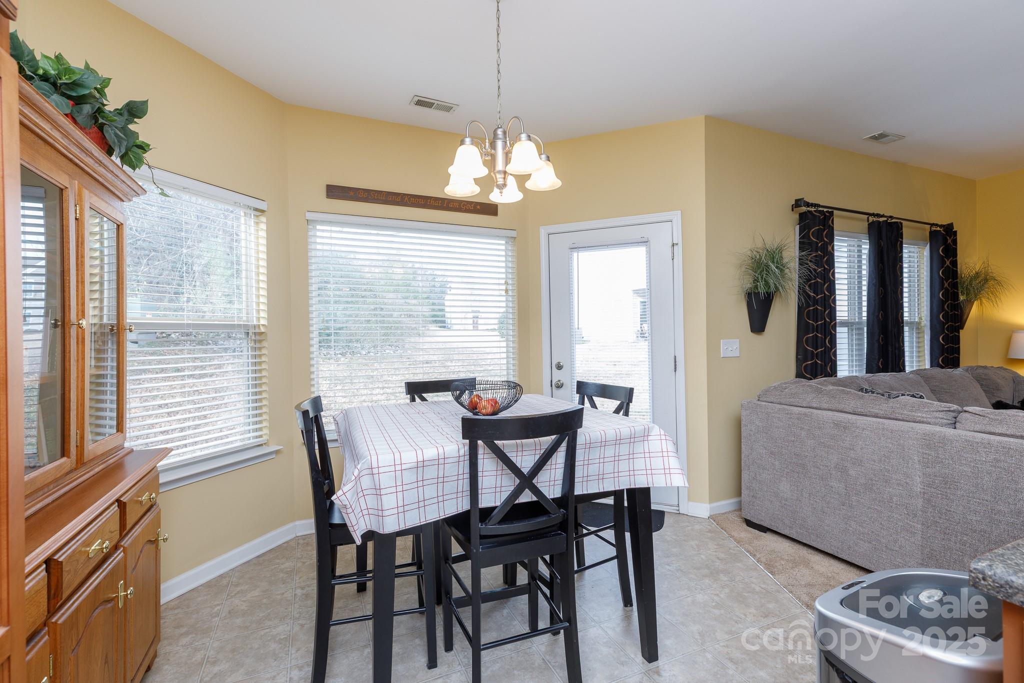 722 Chelton Lane Fort Mill, SC 29715 - Photo 9 of 19 a view of a dining room with furniture and a chandelier