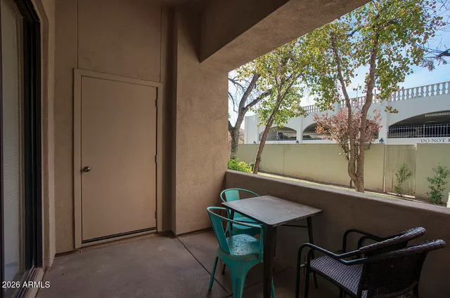 a backyard of a house with table and chairs