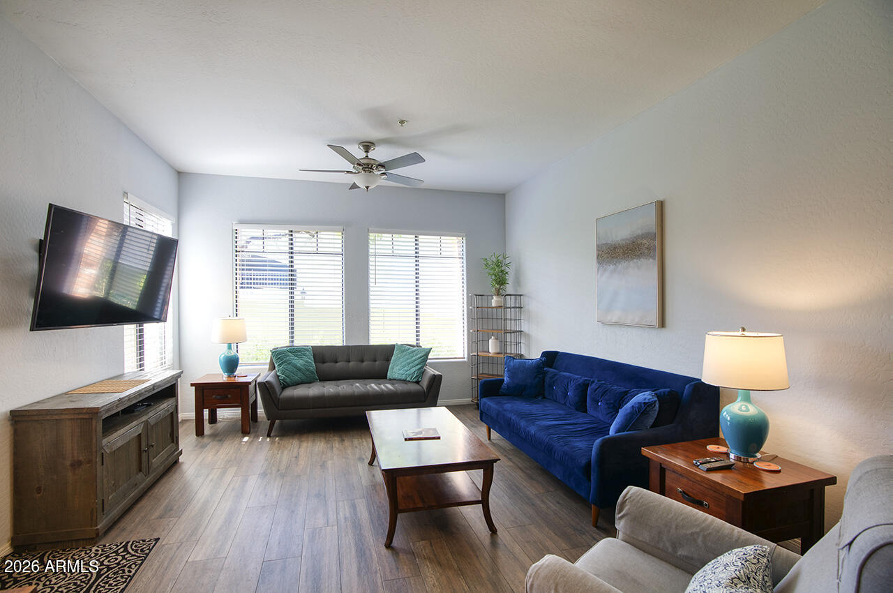 2989 North 44th Street, Unit 1024 Phoenix, AZ 85018 - Photo 5 of 16 a living room with furniture and a flat screen tv