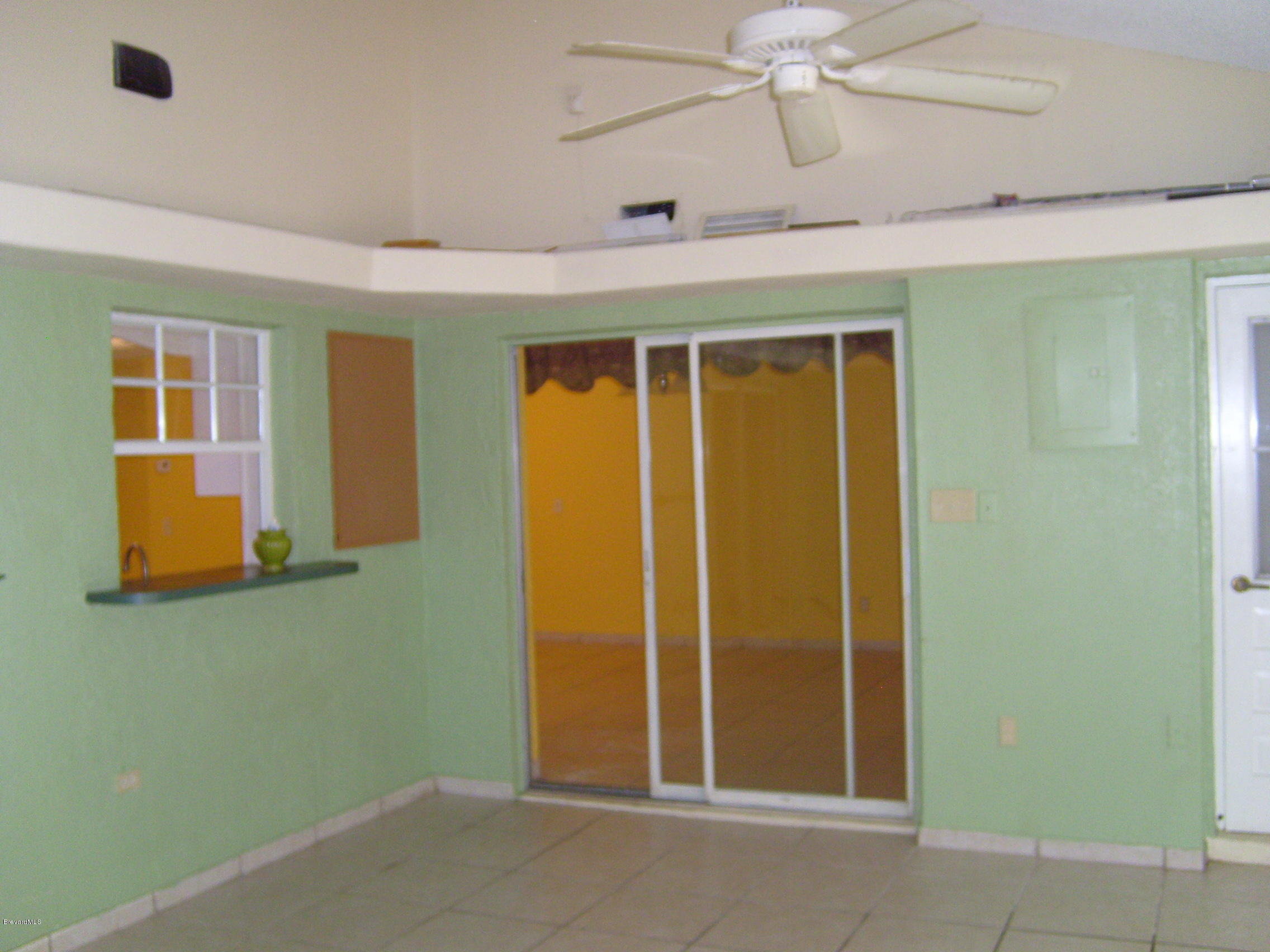 1474 Meadowbrook Road Northeast, Unit NE Palm Bay, FL 32905 - Photo 12 of 24 view of room with window and ceiling fan