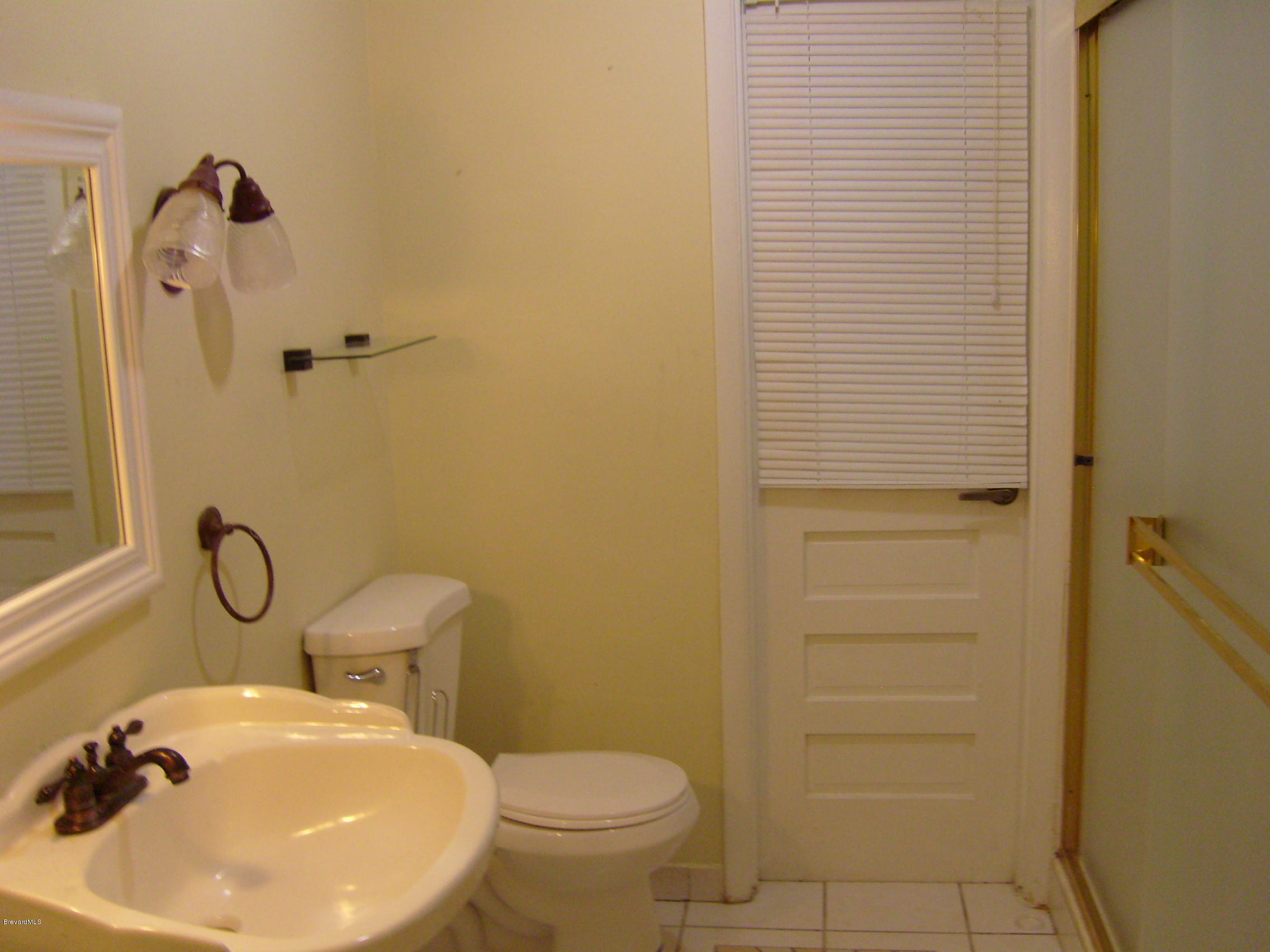 1474 Meadowbrook Road Northeast, Unit NE Palm Bay, FL 32905 - Photo 13 of 24 a bathroom with a sink toilet and shower