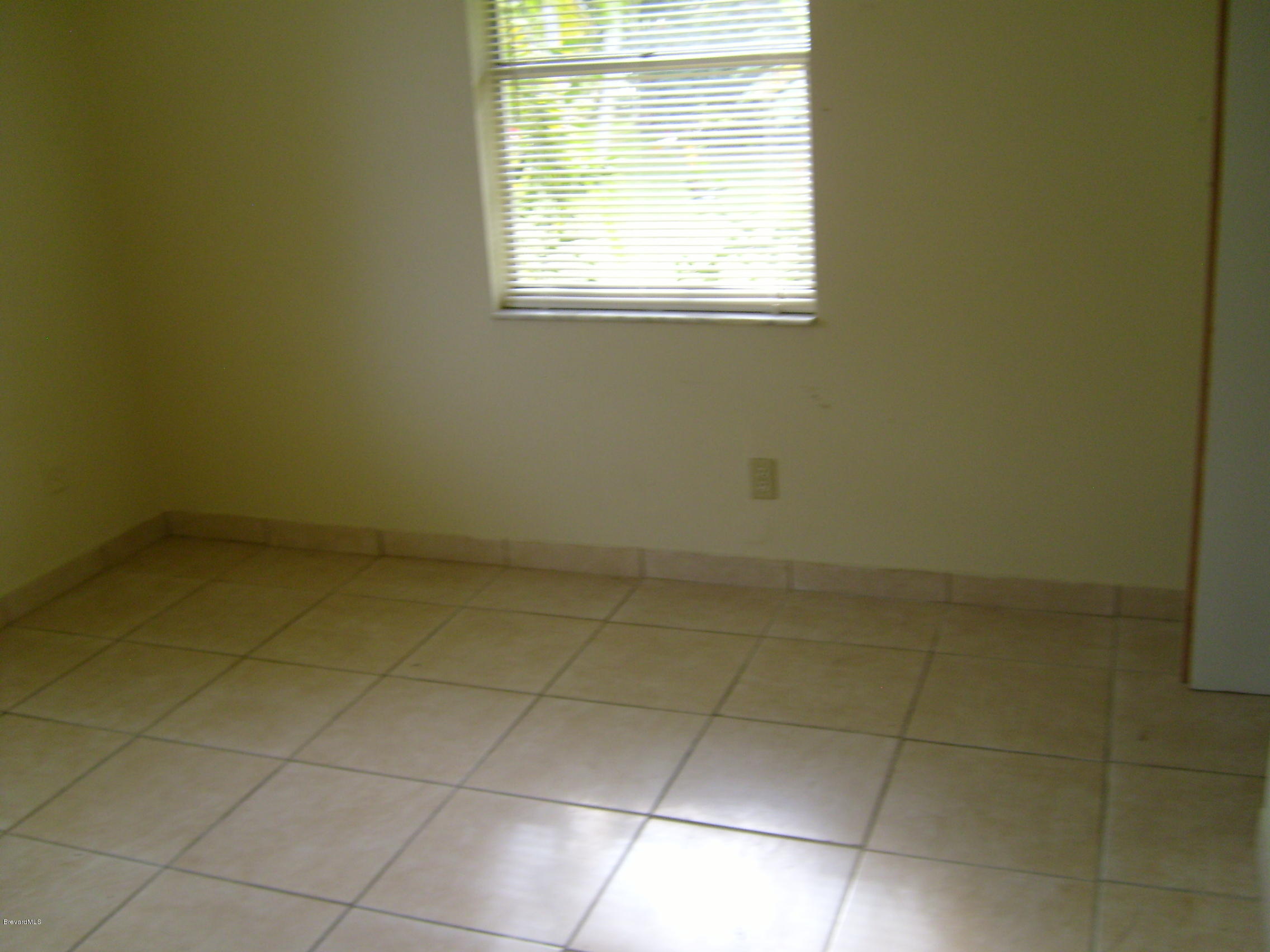 1474 Meadowbrook Road Northeast, Unit NE Palm Bay, FL 32905 - Photo 16 of 24 a view of a room that has a window in it