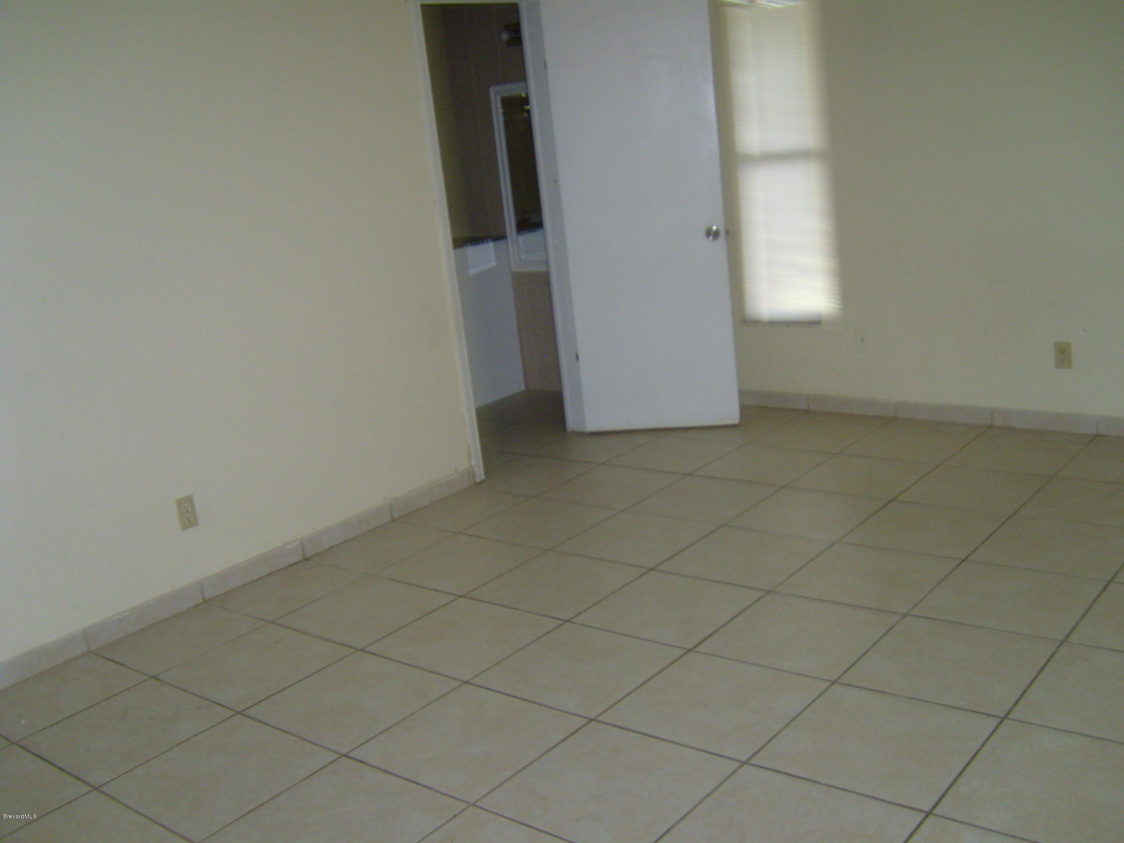 1474 Meadowbrook Road Northeast, Unit NE Palm Bay, FL 32905 - Photo 17 of 24 an empty room with windows