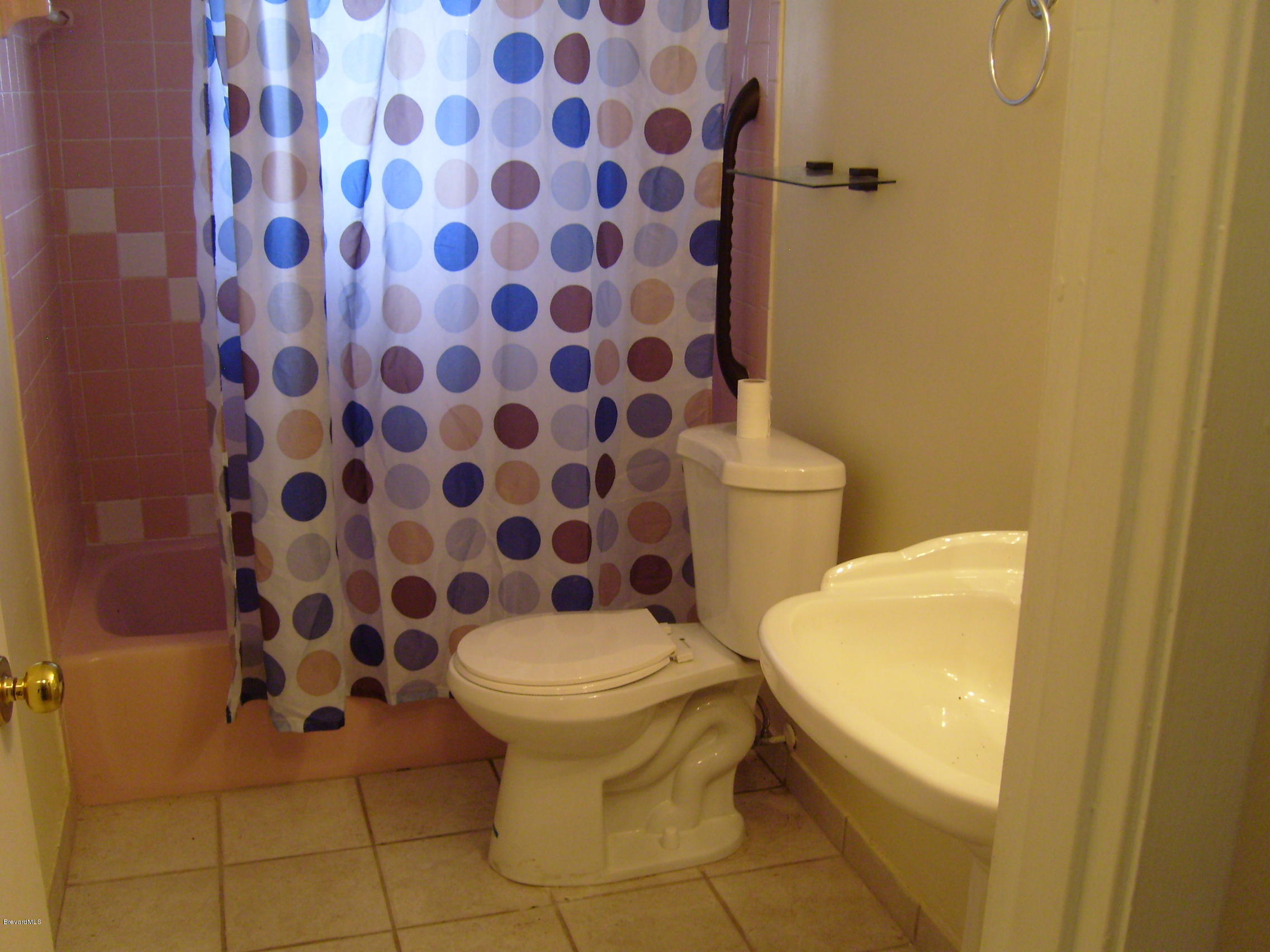 1474 Meadowbrook Road Northeast, Unit NE Palm Bay, FL 32905 - Photo 20 of 24 a bathroom with a sink and toilet