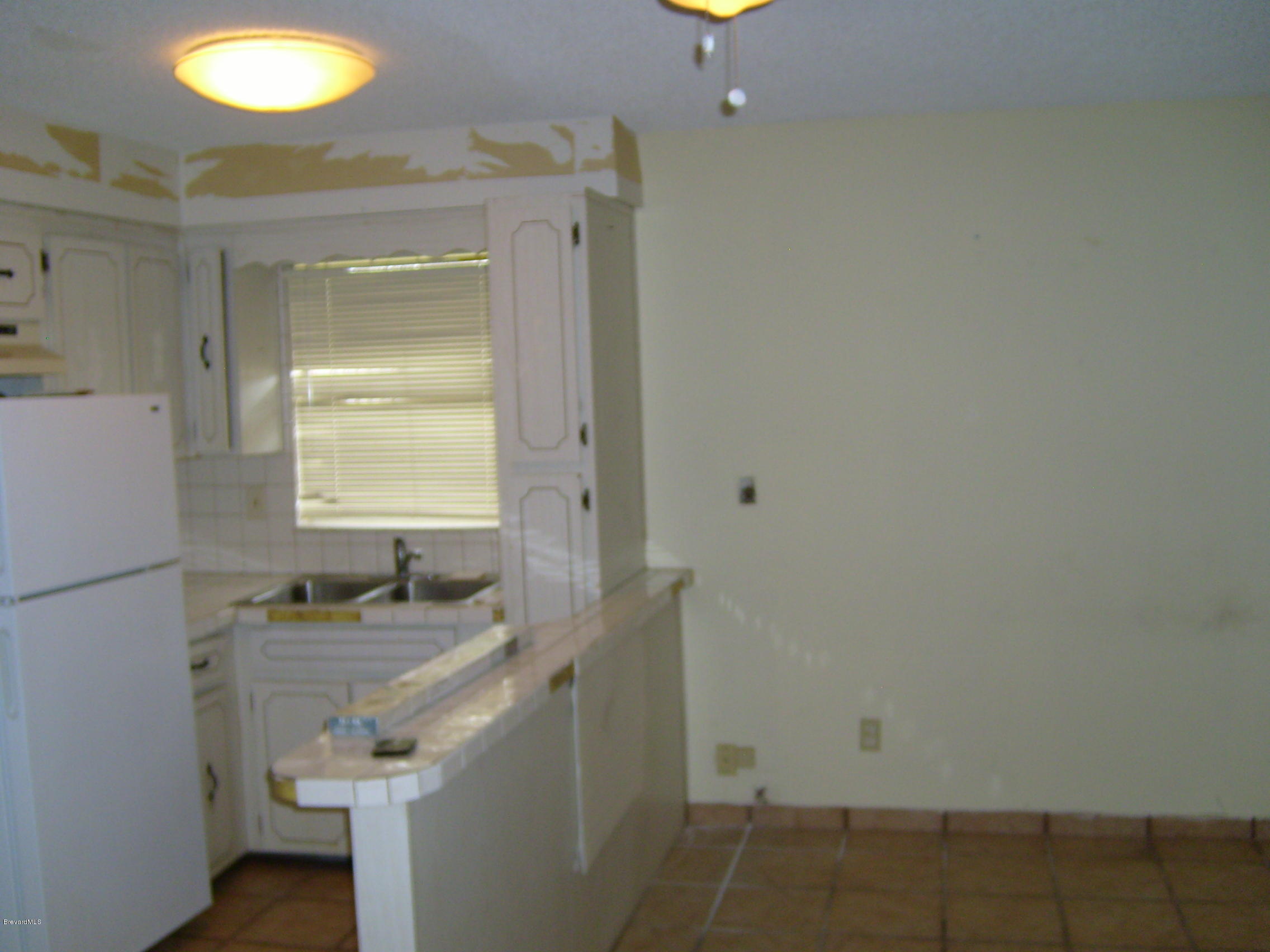1474 Meadowbrook Road Northeast, Unit NE Palm Bay, FL 32905 - Photo 21 of 24 a bathroom with a sink toilet and shower