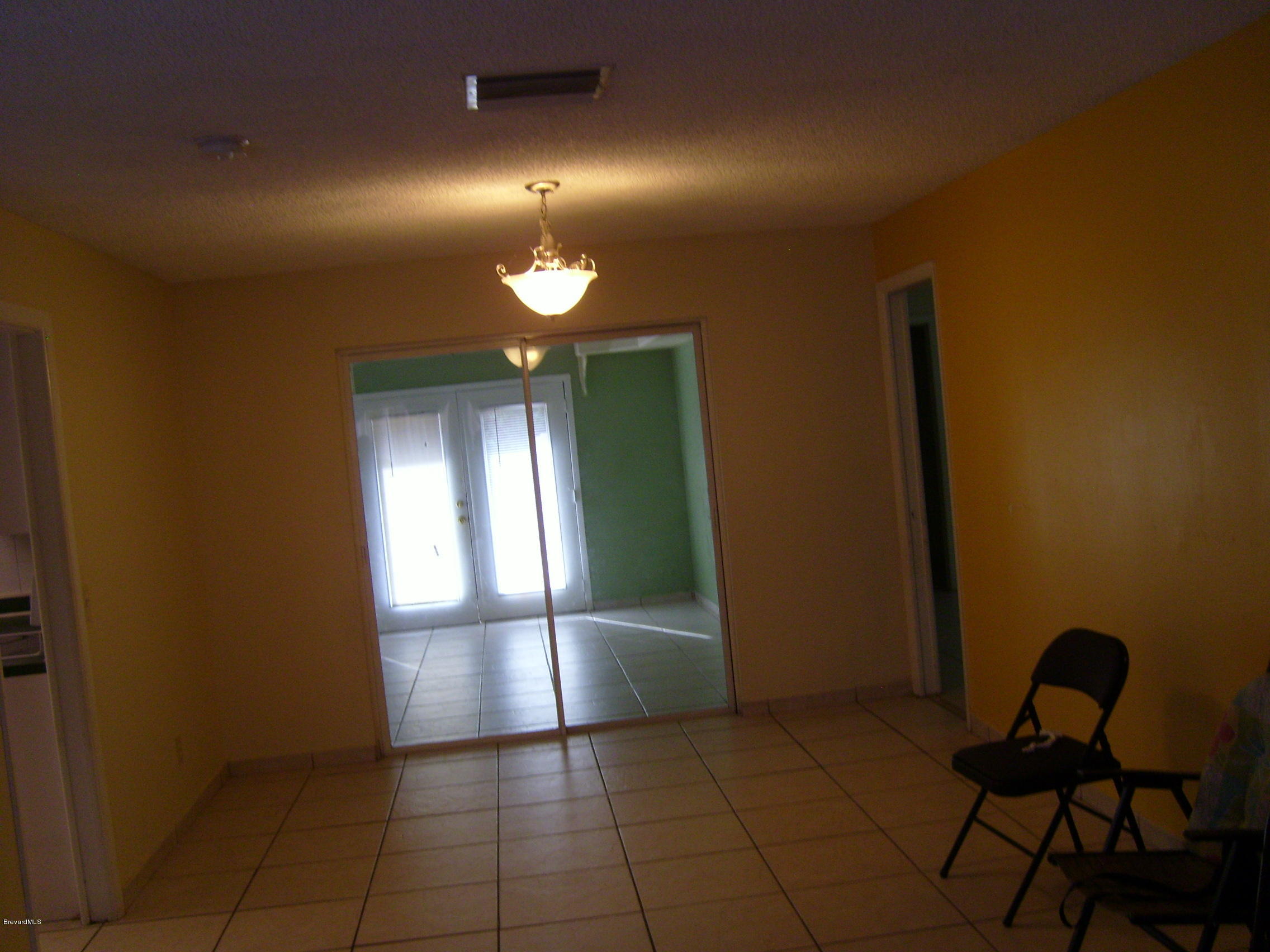 1474 Meadowbrook Road Northeast, Unit NE Palm Bay, FL 32905 - Photo 6 of 24 a view of a livingroom with furniture and wooden floor