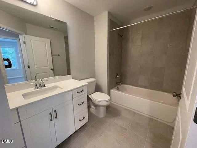 a bathroom with a double vanity sink toilet mirror and bathtub