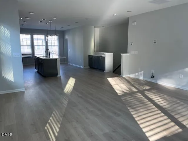 a living room with furniture window and wooden floor