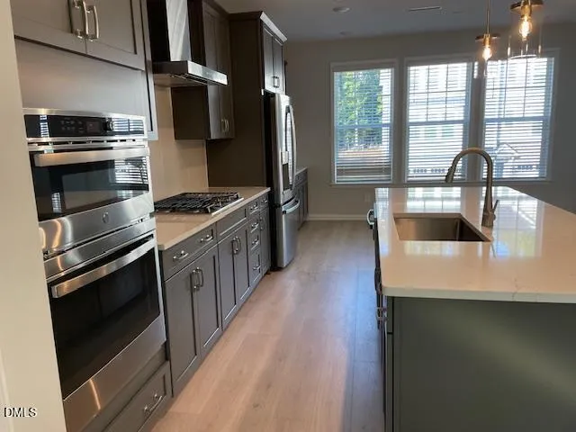 a kitchen with a sink stove and refrigerator
