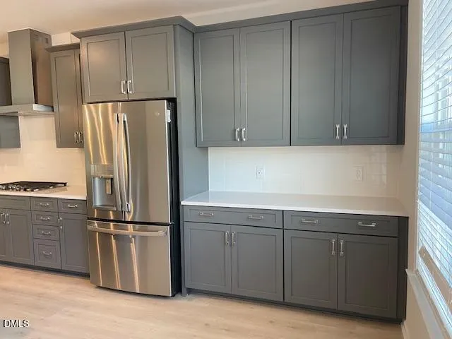 a kitchen with a refrigerator and cabinets