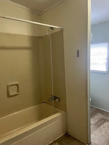 a bathroom with a bathtub and a shower
