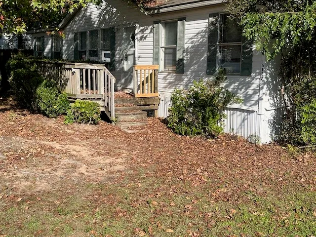 a view of a house with wooden fence