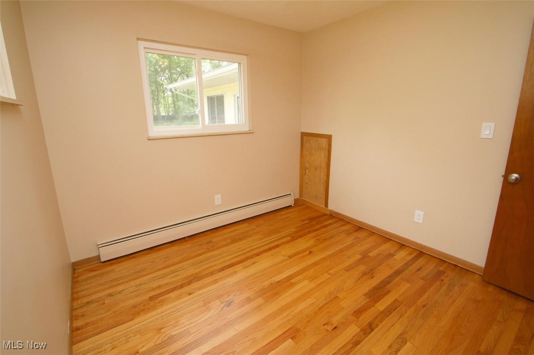 7958 Bellflower Road Mentor, OH 44060 - Photo 20 of 34 Spare room with a baseboard heating unit and light wood-style floors