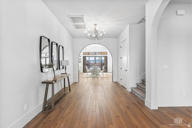 1468 South Red Cliffs Temple Lane St. George, UT 84790 - Photo 6 of 64 Foyer with hardwood / wood-style floors, arched walkways, and a chandelier