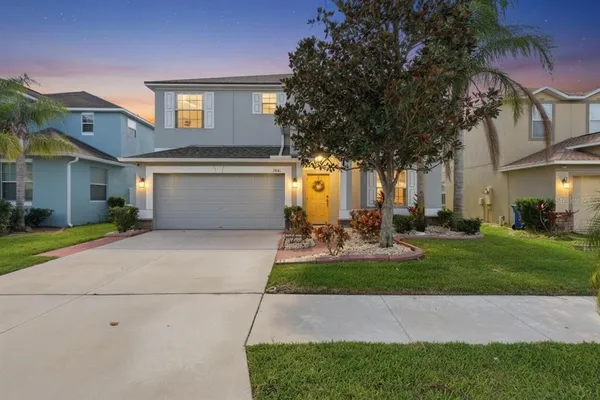 a front view of a house with patio and garden
