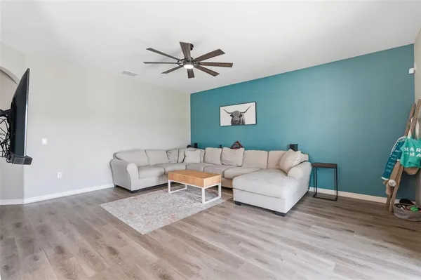 a view of staircase with lots of frames on wall and a window