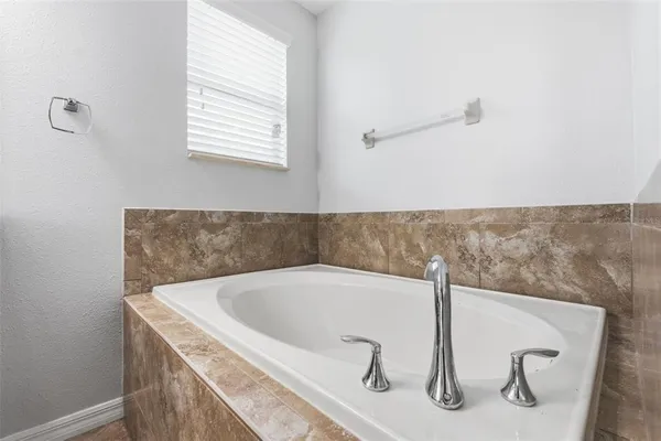 a bathroom with a granite countertop sink and a toilet